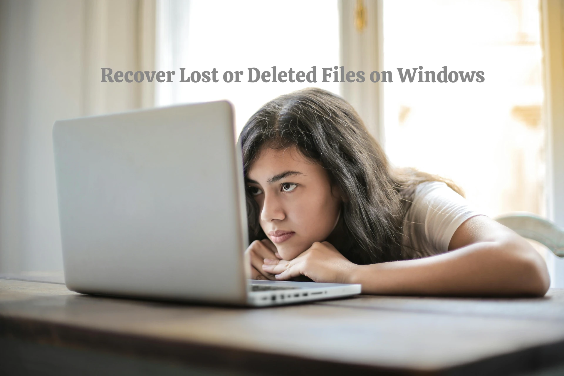 A stressed-looking individual surrounded by multiple computer screens with recovery software interfaces.